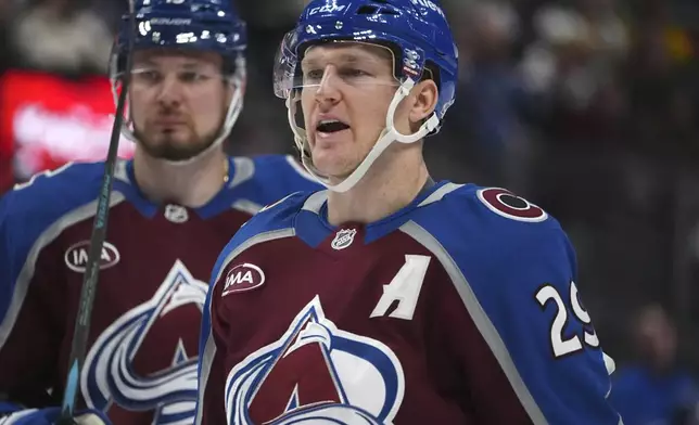 Colorado Avalanche center Nathan MacKinnon, front, argues with a referee as right wing Valeri Nichushkin looks on in the second period of an NHL hockey game against the Vegas Golden Knights Wednesday, Nov. 27, 2024, in Denver. (AP Photo/David Zalubowski)