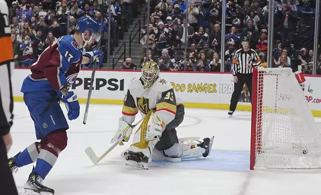 Colorado Avalanche right wing Valeri Nichushkin, left, raises his stick after scoring the winning goal against Vegas Golden Knights goaltender Adin Hill during a shootout in an NHL hockey game Wednesday, Nov. 27, 2024, in Denver. (AP Photo/David Zalubowski)