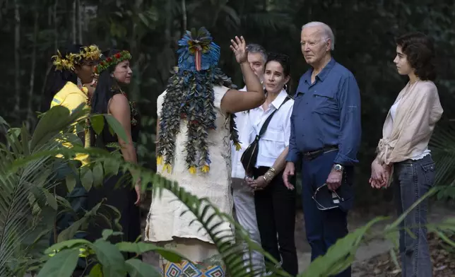 President Joe Biden, second right, joined by daughter Ashley Biden, third from right, and granddaughter Natalie Biden, right, meets with indigenous and other leaders during a tour of the Museu da Amazonia in Manaus, Brazil, Sunday, Nov. 17, 2024. (AP Photo/Manuel Balce Ceneta)