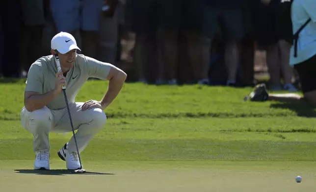 Rory McIlroy of Northern Ireland lines up a putt on the 1st green during the second round of World Tour Golf Championship in Dubai, United Arab Emirates, Saturday, Nov. 16, 2024. (AP Photo/Altaf Qadri)