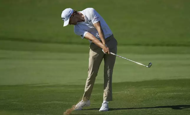 Rasmus Højgaard of Denmark plays his second shot on the16th hole during the second round of World Tour Golf Championship in Dubai, United Arab Emirates, Saturday, Nov. 16, 2024. (AP Photo/Altaf Qadri)