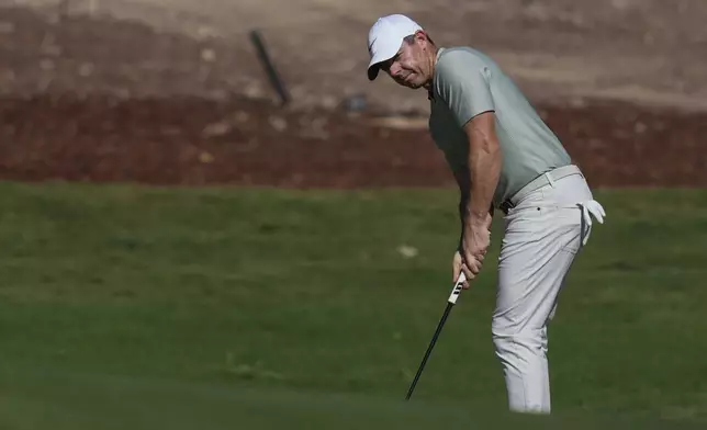 Rory McIlroy of Northern Ireland plays his shot on the 7th green during the second round of World Tour Golf Championship in Dubai, United Arab Emirates, Saturday, Nov. 16, 2024. (AP Photo/Altaf Qadri)