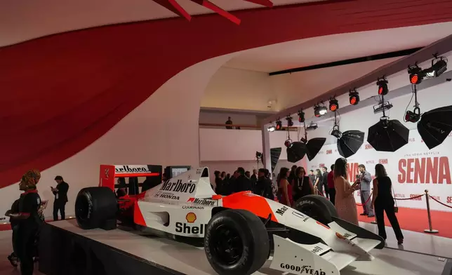 A replica of Formula 1 legend Ayrton Senna's car sits on display on the red carpet for the Netflix series Senna, about the life and death of Formula 1 legend Ayrton Senna, who was killed in a 1994 crash, in Sao Paulo, Tuesday, Nov. 26, 2024. (AP Photo/Andre Penner)