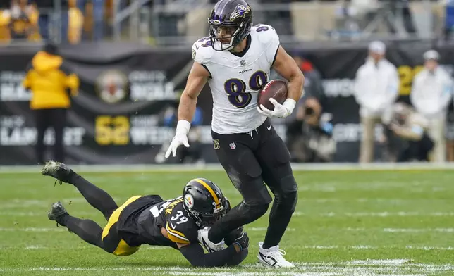 Baltimore Ravens tight end Mark Andrews (89) runs with the ball as Pittsburgh Steelers safety Minkah Fitzpatrick tries to stop him during the second half of an NFL football game, Sunday, Nov. 17, 2024, in Pittsburgh. (AP Photo/Matt Freed)