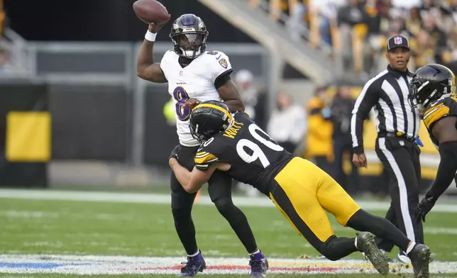 Baltimore Ravens quarterback Lamar Jackson (8) attempts a pass as Pittsburgh Steelers linebacker T.J. Watt (90) applies pressure during the second half of an NFL football game, Sunday, Nov. 17, 2024, in Pittsburgh. (AP Photo/Gene J. Puskar)