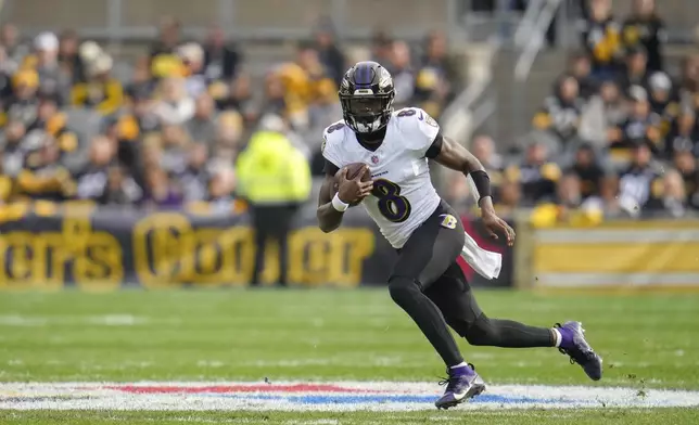 Baltimore Ravens quarterback Lamar Jackson scrambles against the Pittsburgh Steelers during the first half of an NFL football game, Sunday, Nov. 17, 2024, in Pittsburgh. (AP Photo/Gene J. Puskar)