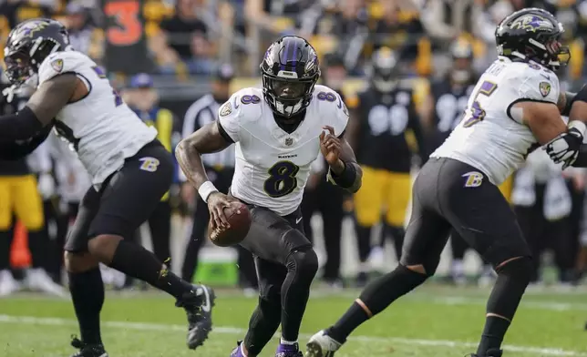 Baltimore Ravens quarterback Lamar Jackson scrambles against the Pittsburgh Steelers during the first half of an NFL football game, Sunday, Nov. 17, 2024, in Pittsburgh. (AP Photo/Matt Freed)