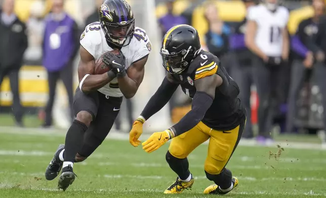 Baltimore Ravens running back Justice Hill (43) runs with the ball as Pittsburgh Steelers linebacker Patrick Queen (6) moves in for the tackle during the second half of an NFL football game, Sunday, Nov. 17, 2024, in Pittsburgh. (AP Photo/Gene J. Puskar)