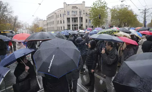 People stopping traffic and standing in silence to commemorate the 15 victims of a railway roof collapse two weeks ago, demand accountability for the tragedy, in Belgrade, Serbia, Friday, Nov. 22, 2024. (AP Photo/Darko Vojinovic)