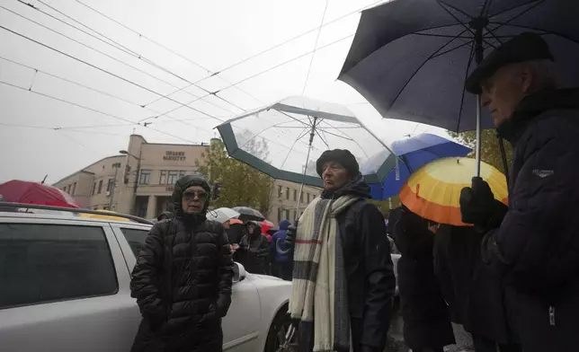 People stopping traffic and standing in silence to commemorate the 15 victims of a railway roof collapse two weeks ago, demand accountability for the tragedy, in Belgrade, Serbia, Friday, Nov. 22, 2024. (AP Photo/Darko Vojinovic)