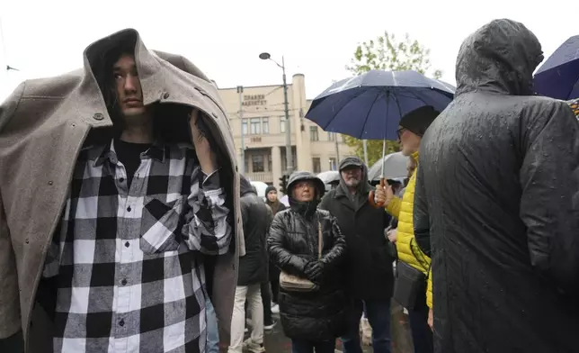 People stopping traffic and standing in silence to commemorate the 15 victims of a railway roof collapse two weeks ago, demand accountability for the tragedy, in Belgrade, Serbia, Friday, Nov. 22, 2024. (AP Photo/Darko Vojinovic)