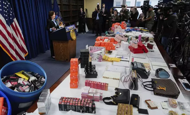 Stolen merchandise is displayed as New York Gov. Kathy Hochul speaks at a news conference on an international stolen merchandise ring, Tuesday, Nov. 26, 2024, in the Queens borough of New York. (AP Photo/Julia Demaree Nikhinson)