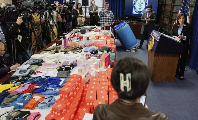 Stolen merchandise is displayed as New York Gov. Kathy Hochul speaks at a press conference on an international stolen merchandise ring, Tuesday, Nov. 26, 2024, in the Queens borough of New York. (AP Photo/Julia Demaree Nikhinson)