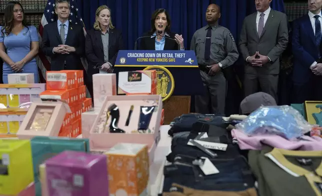 Stolen merchandise is displayed as New York Gov. Kathy Hochul speaks at a news conference on an international stolen merchandise ring, Tuesday, Nov. 26, 2024, in the Queens borough of New York. (AP Photo/Julia Demaree Nikhinson)