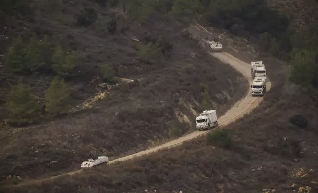 A convoy of the United Nations peacekeeping forces in Lebanon (UNIFIL) drives on area along the Israeli-Lebanese border as seen from northern Israel, Friday, Nov. 29, 2024. (AP Photo/Leo Correa)