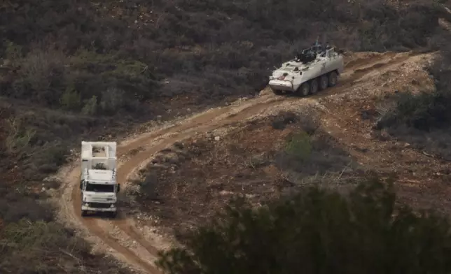 A convoy of the United Nations peacekeeping forces in Lebanon (UNIFIL) drives on area along the Israeli-Lebanese border as seen from northern Israel, Friday, Nov. 29, 2024. (AP Photo/Leo Correa)