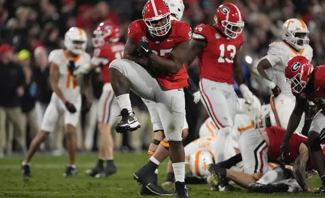 Georgia defensive lineman Warren Brinson (97) react after Bulldogs sacked Tennessee quarterback Nico Iamaleava (8) during the first half of an NCAA college football game, Saturday, Nov. 16, 2024, in Athens, Ga. (AP Photo/John Bazemore)