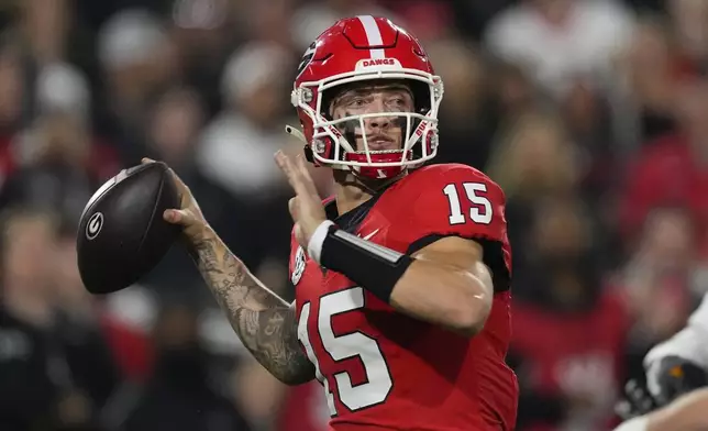 Georgia quarterback Carson Beck (15) looks for an open receiver during the first half of an NCAA college football game against Tennessee, Saturday, Nov. 16, 2024, in Athens, Ga. (AP Photo/John Bazemore)