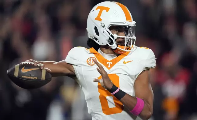 Tennessee quarterback Nico Iamaleava (8) thros a pass during the first half of an NCAA college football game against Georgia, Saturday, Nov. 16, 2024, in Athens, Ga. (AP Photo/John Bazemore)