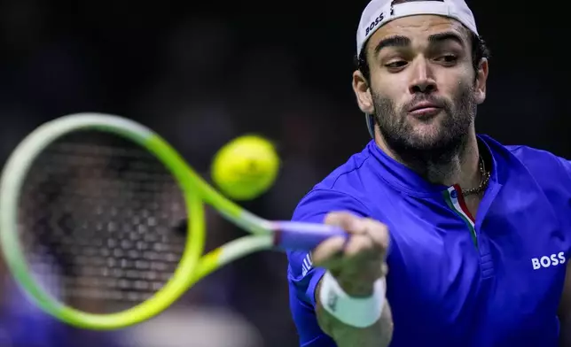 Italy's Matteo Berrettini returns the ball against Netherlands' Botic van de Zandschulp during the Davis Cup final tennis match between Netherlands and Italy at the Martin Carpena Sports Hall in Malaga, southern Spain, on Sunday, Nov. 24, 2024. (AP Photo/Manu Fernandez)