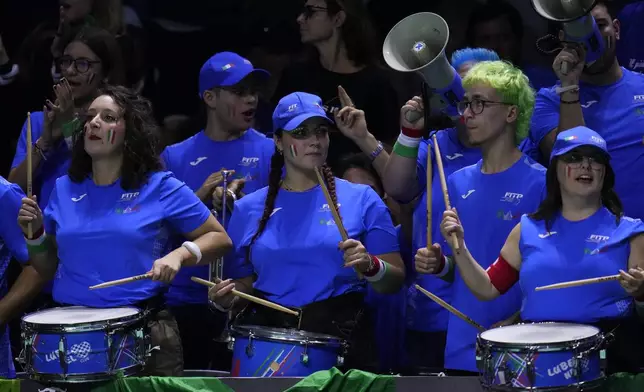 Supporters of Italy's Jannik Sinner play the drums as he plays Netherlands' Tallon Griekspoor during the Davis Cup final tennis match between Netherlands and Italy at the Martin Carpena Sports Hall in Malaga, southern Spain, Sunday, Nov. 24, 2024. (AP Photo/Manu Fernandez)