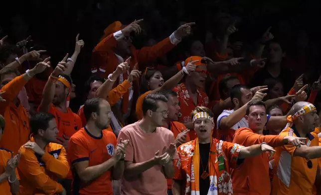 Dutch tennis fans gesture while Netherlands' Tallon Griekspoor plays Italy's Jannik Sinner during the Davis Cup final tennis match between Netherlands and Italy at the Martin Carpena Sports Hall in Malaga, southern Spain, Sunday, Nov. 24, 2024. (AP Photo/Manu Fernandez)