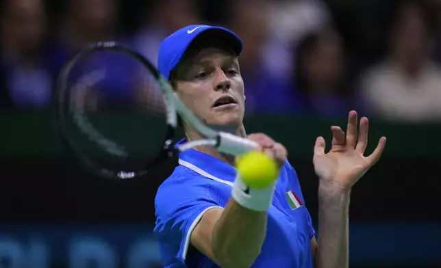 Italy's Jannik Sinner returns the ball to Netherlands' Tallon Griekspoor during the Davis Cup final tennis match between Netherlands and Italy at the Martin Carpena Sports Hall in Malaga, southern Spain, Sunday, Nov. 24, 2024. (AP Photo/Manu Fernandez)