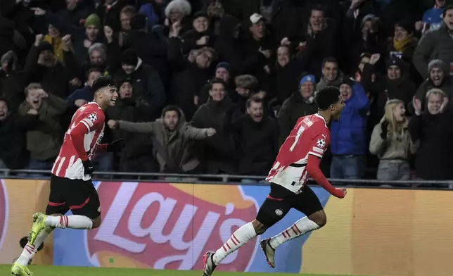 PSV's Malik Tillman, right, celebrates after scoring his sides first goal during the Champions League opening phase soccer match between PSV Eindhoven and Shakhtar Donetsk at the PSV Stadium in Eindhoven, Netherlands, Wednesday, Nov. 27, 2024. (AP Photo/Patrick Post)