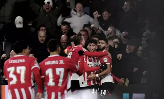 PSV's Ricardo Pepi, center, celebrates after scoring his sides third goal during the Champions League opening phase soccer match between PSV Eindhoven and Shakhtar Donetsk at the PSV Stadium in Eindhoven, Netherlands, Wednesday, Nov. 27, 2024. (AP Photo/Patrick Post)