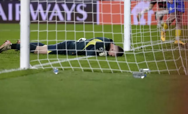 Shakhtar's goalkeeper Dmytro Riznyk lays in the goal after PSV's Ricardo Pepi scored his sides third goal during the Champions League opening phase soccer match between PSV Eindhoven and Shakhtar Donetsk at the PSV Stadium in Eindhoven, Netherlands, Wednesday, Nov. 27, 2024. (AP Photo/Patrick Post)