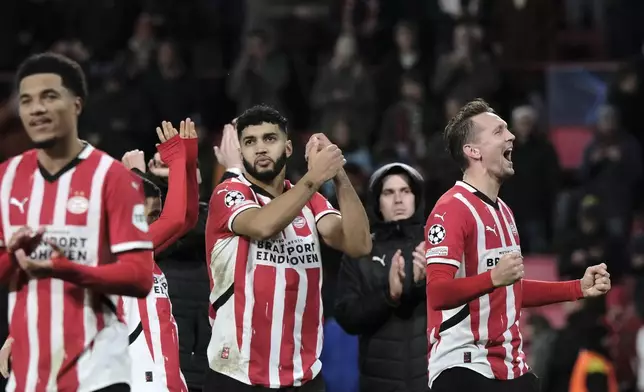 PSV players celebrate after winning their Champions League opening phase soccer match between PSV Eindhoven and Shakhtar Donetsk at the PSV Stadium in Eindhoven, Netherlands, Wednesday, Nov. 27, 2024. (AP Photo/Patrick Post)