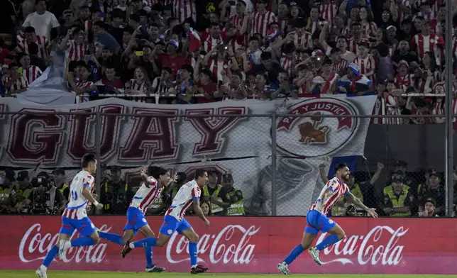 Paraguay's Omar Alderete, right, celebrates scoring his side's second goal against Argentina during a qualifying soccer match for the FIFA World Cup 2026 in Asuncion, Paraguay, Thursday, Nov. 14, 2024. (AP Photo/Jorge Saenz)