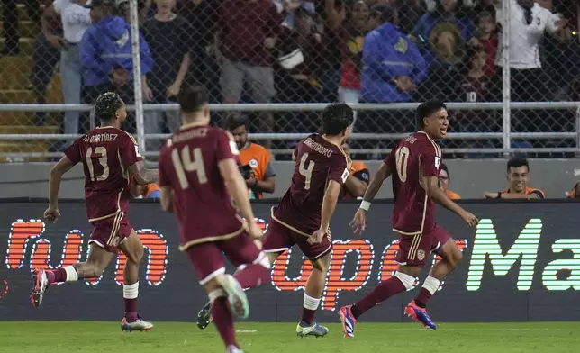 Venezuela's Telasco Segovia, right, celebrates with teammates after scoring his side's first goal against Brazil during a FIFA World Cup 2026 qualifying soccer match at Monumental stadium in Maturin, Venezuela, Thursday, Nov. 14, 2024. (AP Photo/Ariana Cubillos)