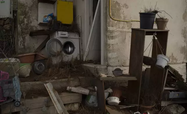 A washing machine stands outside of a damaged house in the Kibbutz Manara, which is located near to the border with Lebanon, in the northern Israel, Thursday, Nov. 28, 2024. (AP Photo/Leo Correa)