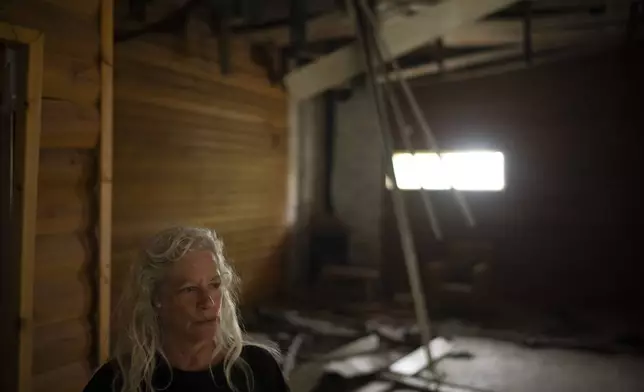 CORRECTS SURNAME.- Orna Weinberg stands at the damaged dining hall, that was hit by a rocket fired from Lebanon, in the Kibbutz Manara, northern Israel, Thursday, Nov. 28, 2024. (AP Photo/Leo Correa)