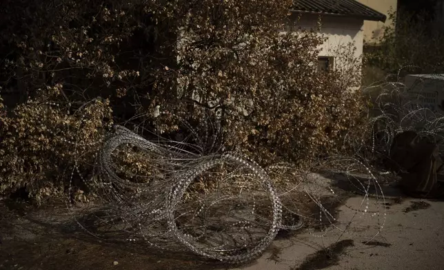 Barbed wires are set on an area in front a house of the Kibbutz Manara, which is located near to the border with Lebanon in the northern Israel, Thursday, Nov. 28, 2024. (AP Photo/Leo Correa)