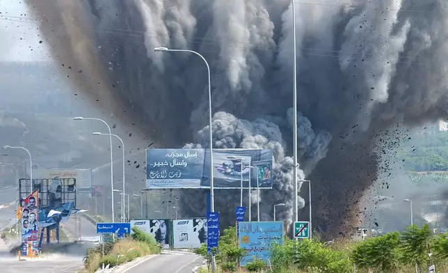 FILE - Smoke rises and debris flies from a bridge as it is targeted by an Israeli air raid, in the Zahrani region, on the Mediterranean coast, southern Lebanon, on July 14, 2006. (AP Photo/Mohammed Zaatari, File)