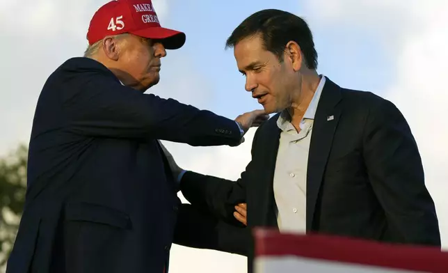 FILE - Then former President Donald Trump pats Sen. Marco Rubio, R-Fla., on the shoulder during a campaign rally at the Miami-Dade County Fair and Exposition in Miami, Nov. 6, 2022. (AP Photo/Rebecca Blackwell, File)