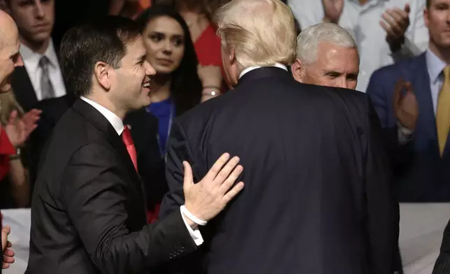 FILE - Sen. Marco Rubio, R-Fla., walks off the stage with President Donald Trump after a speech where Trump revised a Cuba policy, in Miami, June 16, 2017. (AP Photo/Lynne Sladky, File)