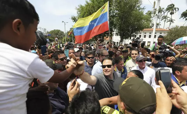 FILE - U.S. Senator Marco Rubio, R-Fla., greets Venezuelan migrants near the Simon Bolivar International Bridge, in La Parada, near Cucuta, Colombia, Feb. 17, 2019. (AP Photo/Fernando Vergara, File)