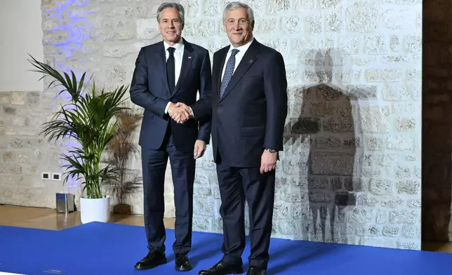 Italy's Foreign Minister Antonio Tajani, right, welcomes US Secretary of State Antony Blinken at the G7 Foreign Ministers meeting in Anagni, central Italy, Monday, Nov. 25, 2024. (Andreas Solaro/Pool Photo via AP)