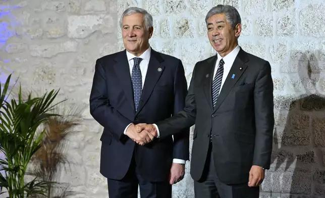 Italy's Foreign Minister Antonio Tajani, left, welcomes Japan's Foreign Minister Takeshi Iwaya at the G7 Foreign Ministers meeting in Anagni, central Italy, Monday, Nov. 25, 2024. (Andreas Solaro/Pool Photo via AP)