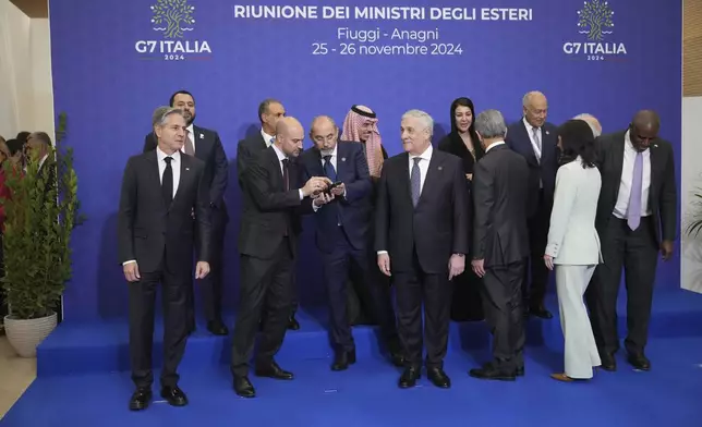 Foreign Ministers of the G7 and from different Arab countries wait to pose for a family photo at the G7 of foreign Ministers in Fiuggi, some 70 kilometers south-east of Rome, Monday, Nov. 25, 2024. (AP Photo/Alessandra Tarantino)