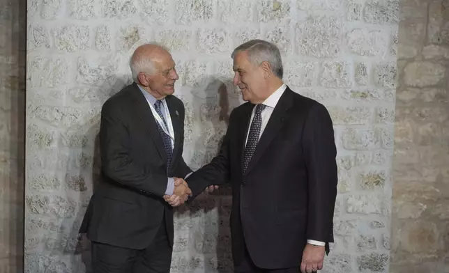 Italian Foreign Minister Antonio Tajani, right, greets European Union foreign policy chief Josep Borrell as he arrives for a family photo at the G7 of foreign Ministers in Anagni, some 70 kilometers south-east of Rome, Monday, Nov. 25, 2024. (AP Photo/Alessandra Tarantino)