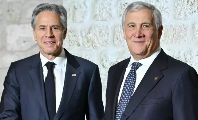 Italy's Foreign Minister Antonio Tajani, right, welcomes US Secretary of State Antony Blinken at the G7 Foreign Ministers meeting in Anagni, central Italy, Monday, Nov. 25, 2024. (Andreas Solaro/Pool Photo via AP)