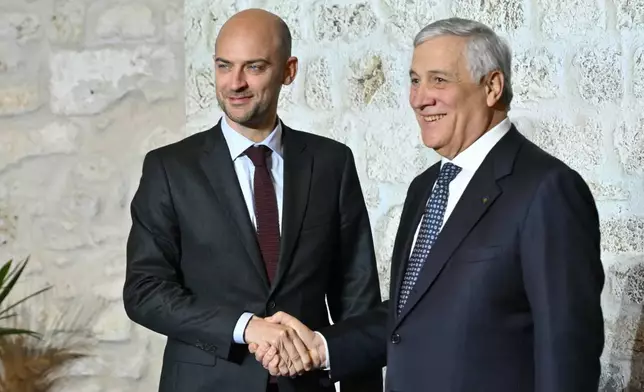 Italy's Foreign Minister Antonio Tajani, right, welcomes France's Foreign Affairs Minister Jean-Noel Barrot at the G7 Foreign Ministers meeting in Anagni, central Italy, Monday, Nov. 25, 2024. (Andreas Solaro/Pool Photo via AP)