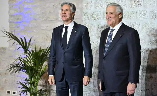 Italy's Foreign Minister Antonio Tajani, right, welcomes U.S. Secretary of State Antony Blinken at the G7 Foreign Ministers meeting in Anagni, central Italy, Monday, Nov. 25, 2024. (Andreas Solaro/Pool Photo via AP)