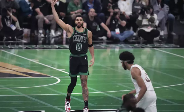 Boston Celtics forward Jayson Tatum (0) celebrates after hitting a 3-pointer during the second half of an Emirates NBA Cup basketball game against the Cleveland Cavaliers, Tuesday, Nov. 19, 2024, in Boston. (AP Photo/Charles Krupa)