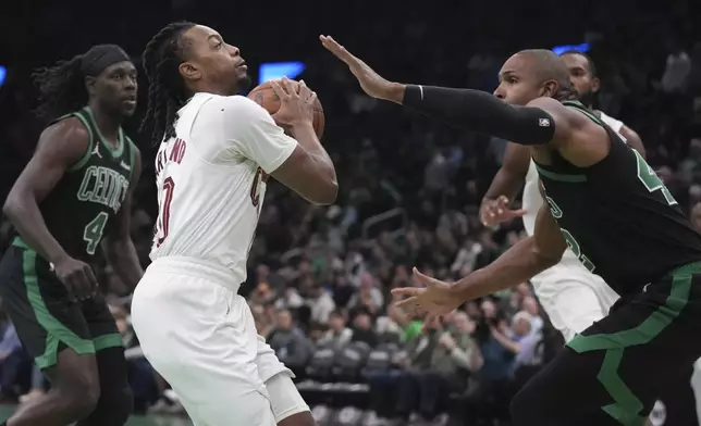 Cleveland Cavaliers guard Darius Garland (10) drives to the basket against Boston Celtics center Al Horford, right, during the first half of an Emirates NBA Cup basketball game, Tuesday, Nov. 19, 2024, in Boston. (AP Photo/Charles Krupa)