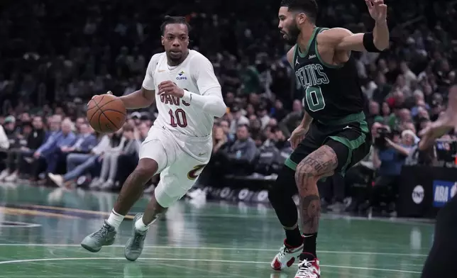 Cleveland Cavaliers guard Darius Garland (10) drives to the basket against Boston Celtics forward Jayson Tatum (0) during the first half of an Emirates NBA Cup basketball game, Tuesday, Nov. 19, 2024, in Boston. (AP Photo/Charles Krupa)